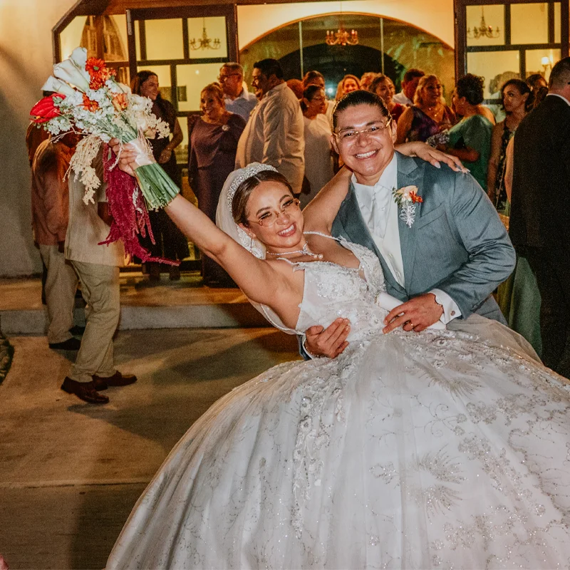 Bride and groom celebrating on a lit dance floor