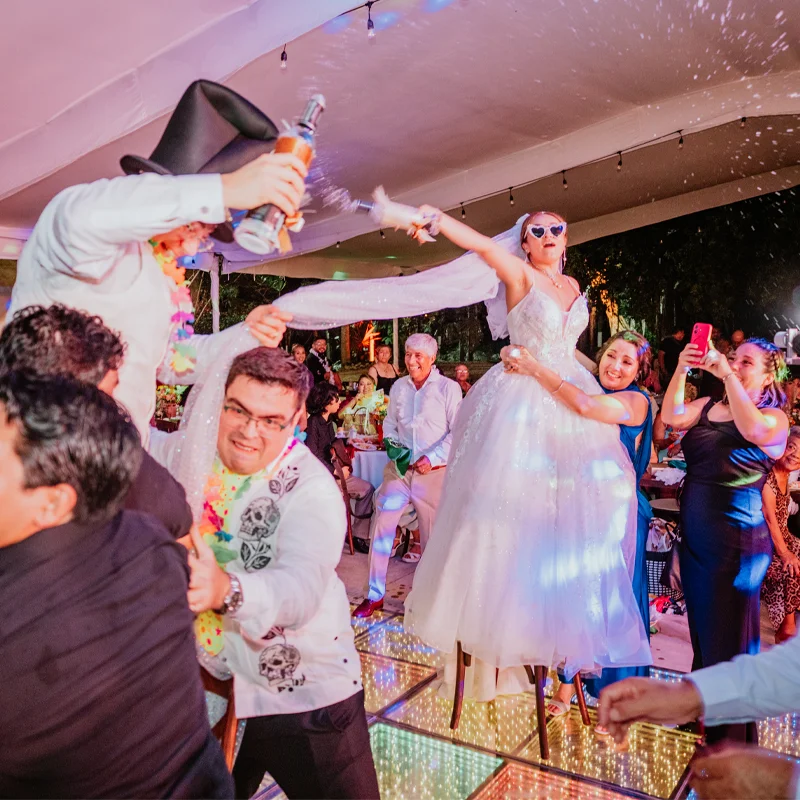 Group of guests celebrating with the couple on the dance floor