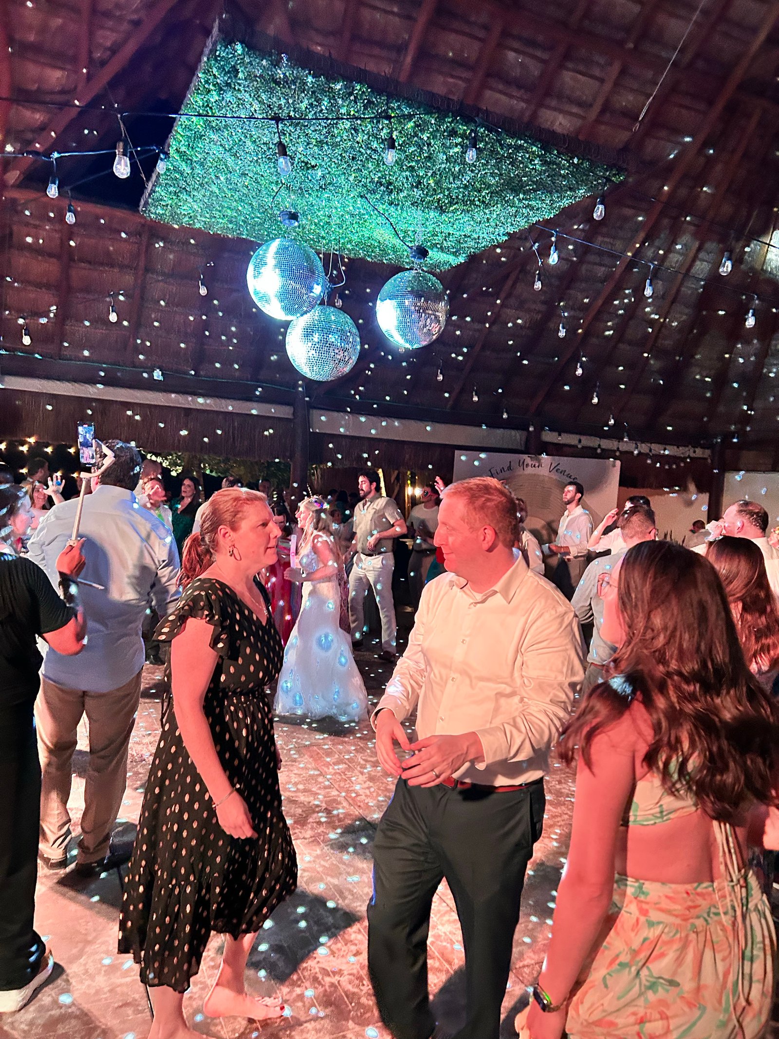 Guests dancing under disco balls at an all-inclusive Riviera Maya wedding