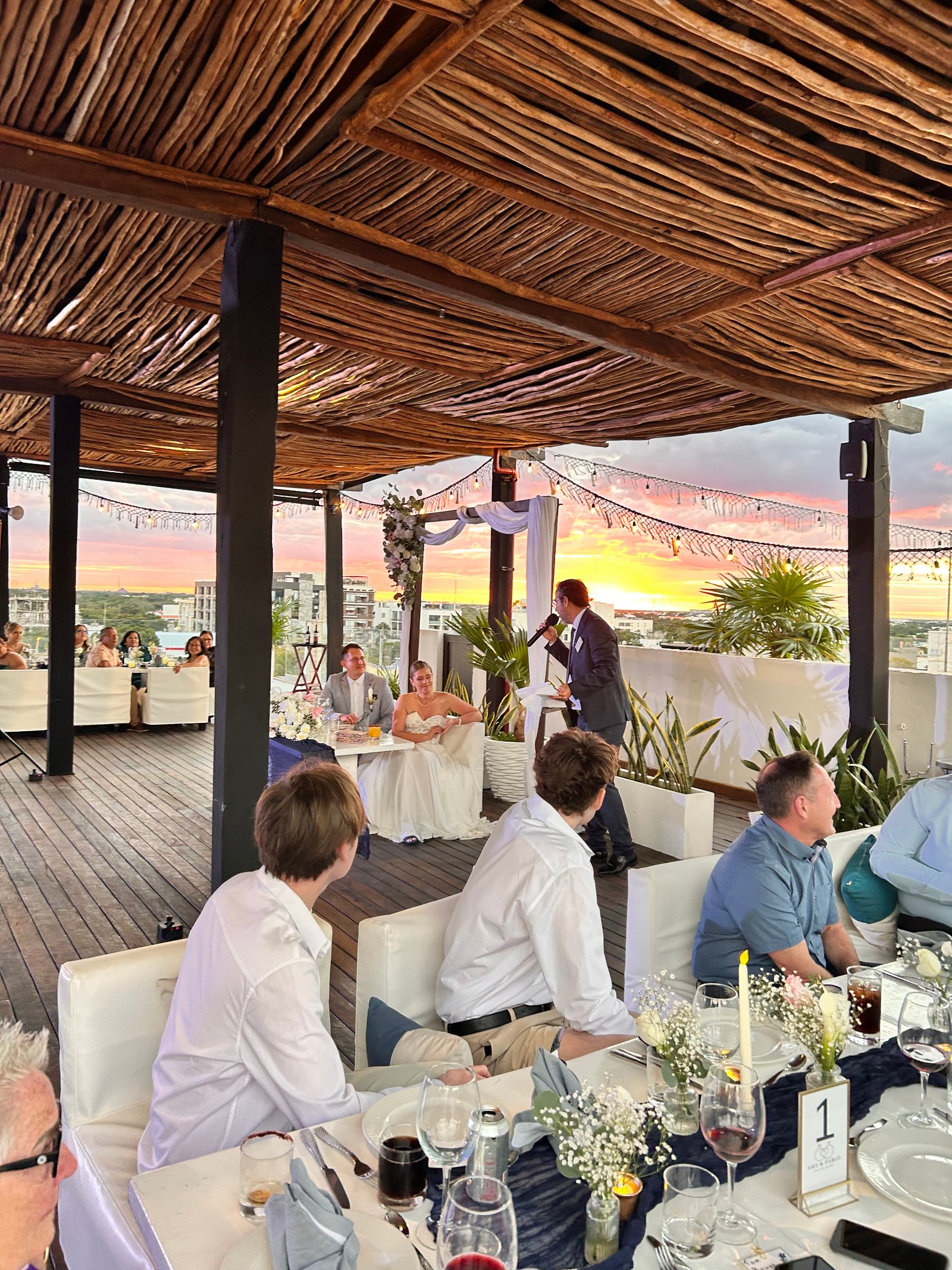 Sunset rooftop wedding reception speech in the Riviera Maya