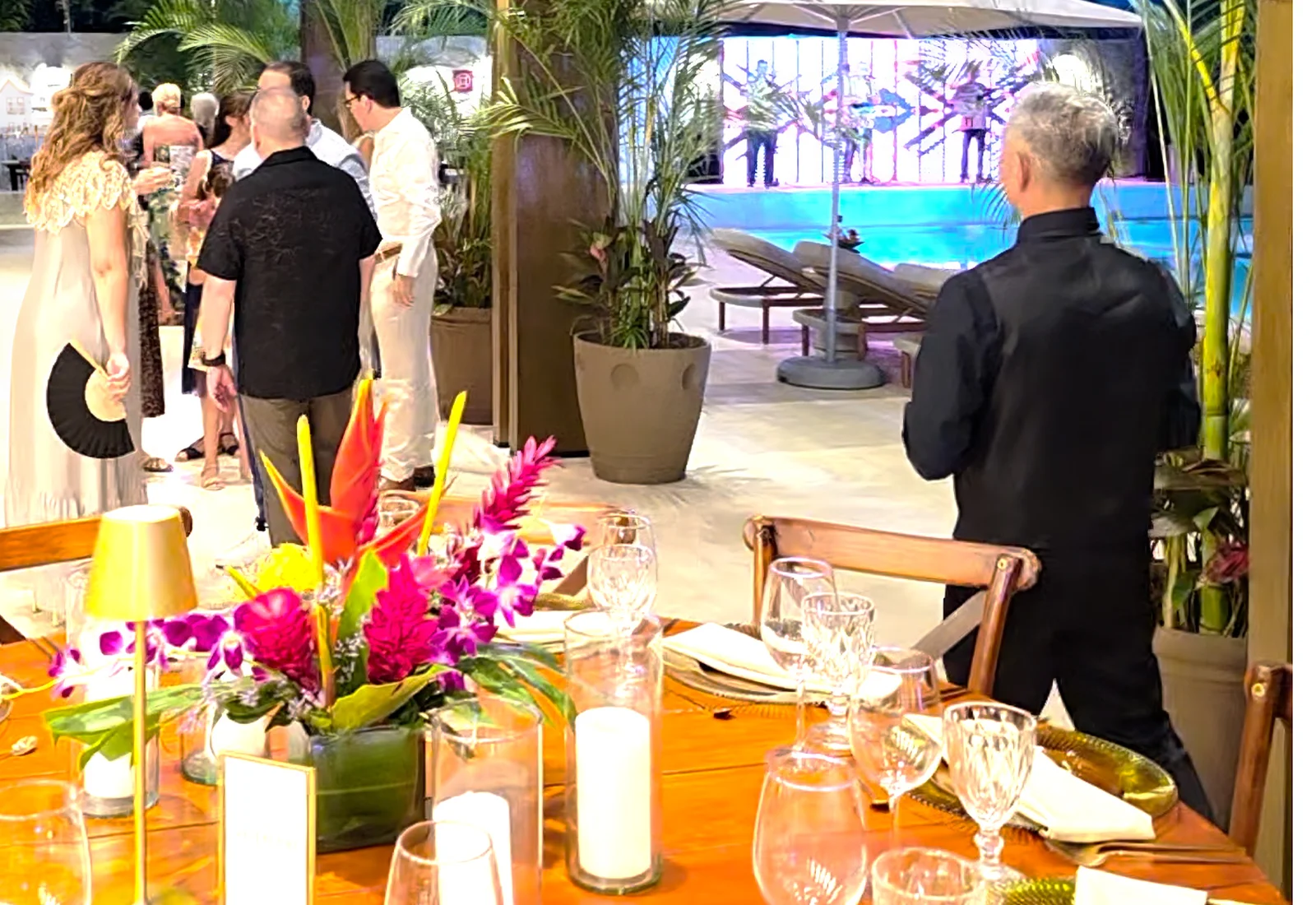 Modern corporate event venue with tropical plants and hanging lights